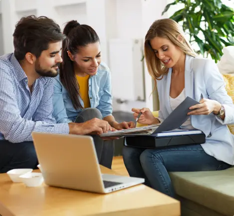 Agent showing customers documents while sitting down
